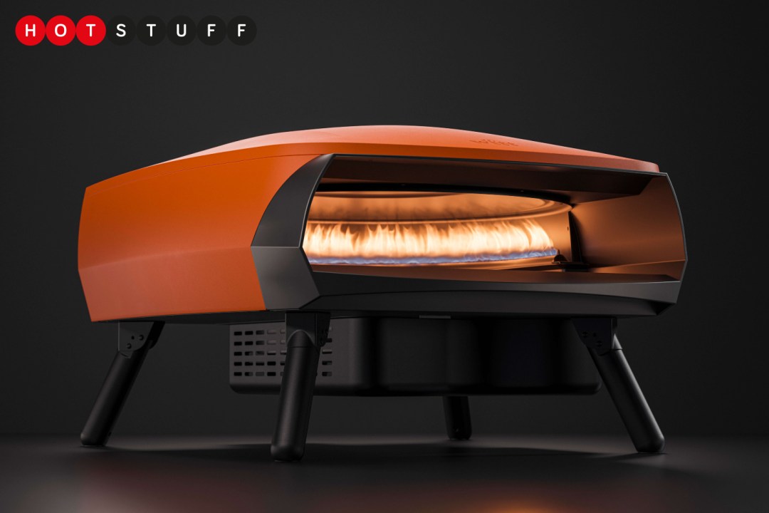 An orange Witt Etna Rotante pizza oven with the burner lit