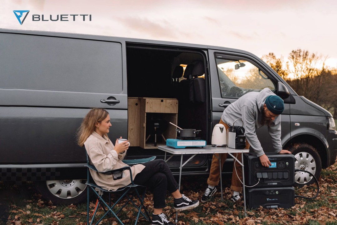 Bluetti AC300 being used by a couple with a campervan