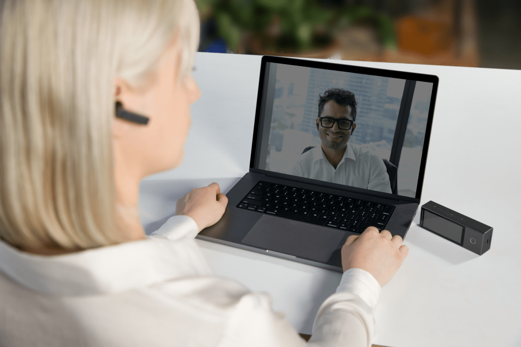 Timekettle X1 Interpreter Hub being used alongside a laptop